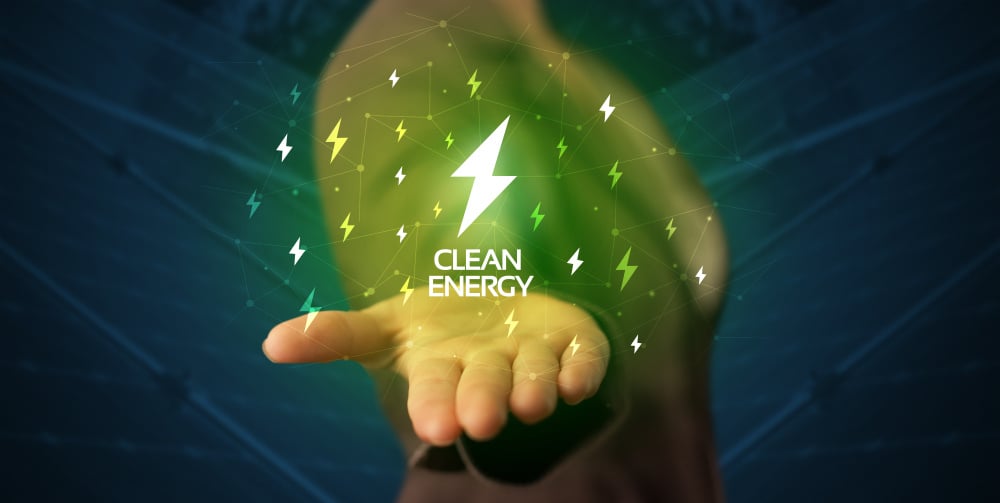 Électrification : le difficile abandon du thermique Hand in suit holding lightning bolt on his hand, green environment concept