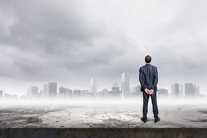 Back view of confident businessman looking at city