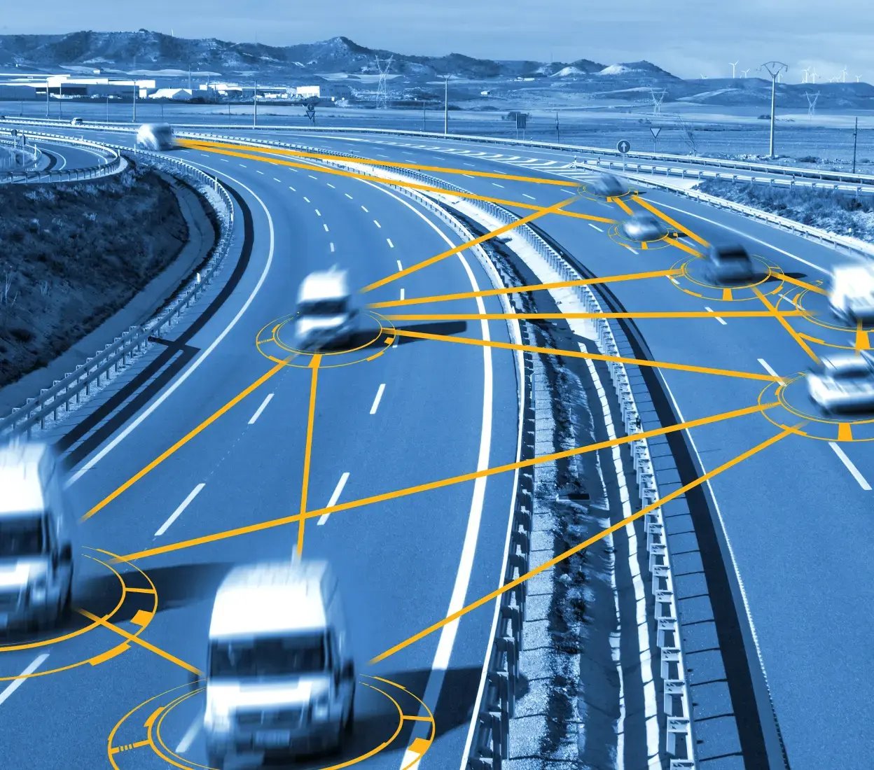 Vehicles driving in opposite directions on adjacent dual carriageways, connected by bold yellow lines