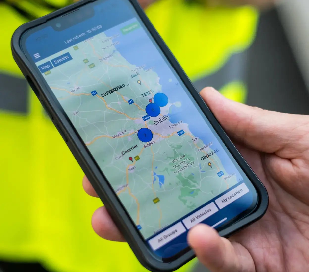 Smartphone showing live vehicle tracking data on a detailed map