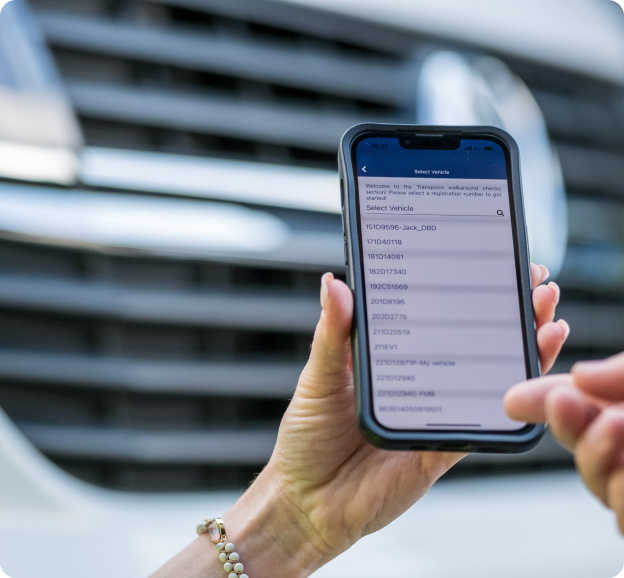 Close-up of a smartphone displaying vehicle telematics data