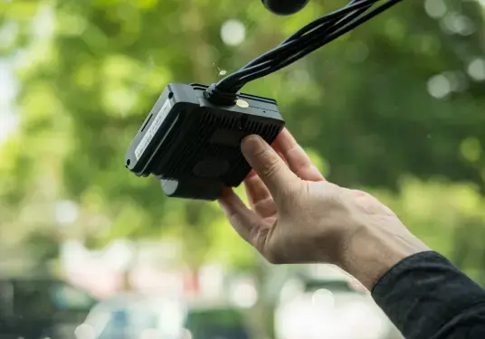 Driver installing a Transpoco device onto his windscreen