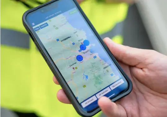 Smartphone showing live vehicle tracking data on a detailed map